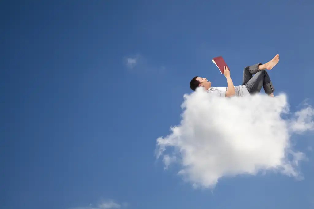 Easy, cozy. Image of a man resting on a cloud.